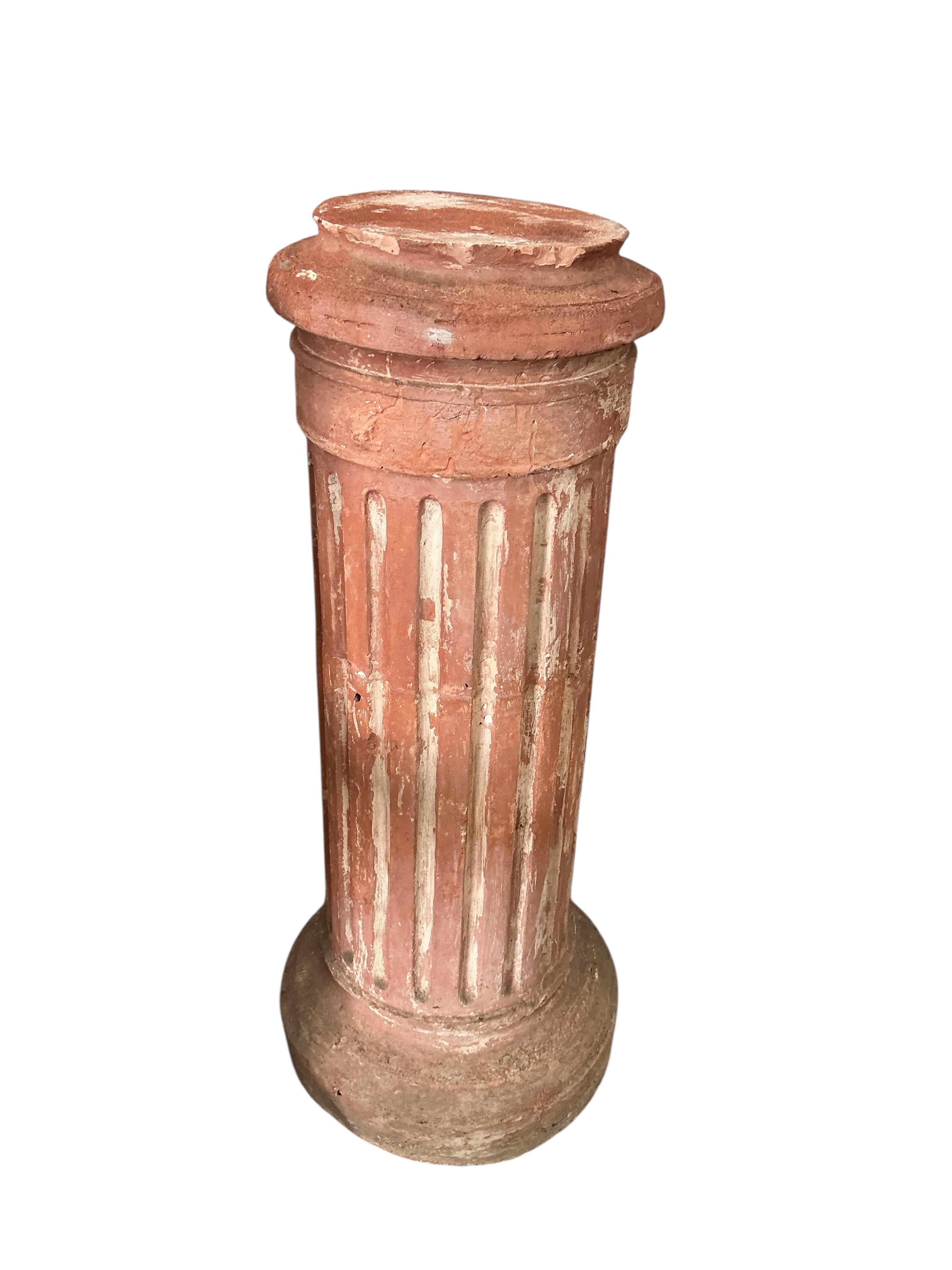 A pair of Neoclassical Revival terracotta busts on fluted pedestals, larger height 188cm, Provenance: The late Kenneth Turner (1936-2025), celebrity florist, designer and perfume retailer, he received the Royal Warrant f